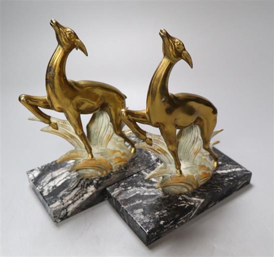 A pair of Art Deco cast metal deer bookends, on black veined marble plinths, height 21cm